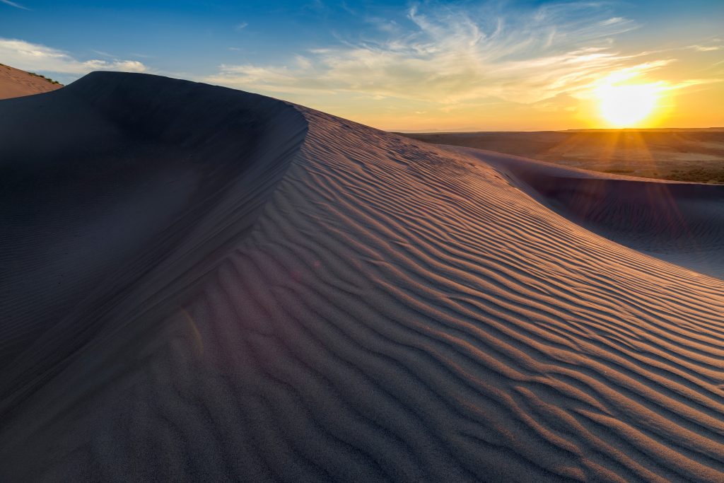 Sunset over a rippled sand dune at Bruneau Sand Dunes.