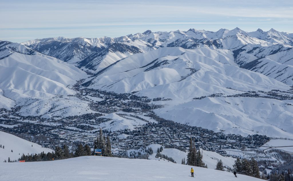 View at Sun Valley Ski Resort over the town of Ketchum from a snowy mountain slope.